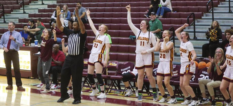 The St. Cloud Bulldogs celebrate one of their nine three-pointers in Friday’s District 6A-7 championship victory. PHOTO/ROB HERBERT