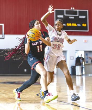 Veteran and youth: Senior Gateway center Evana Rivera (11) drives on St. Cloud freshman Aa’Raeyiah Andersen (32) in a game Friday at Gateway. The two teams have met in the Orange Belt Conference championship game the last three seasons. (Photo/Taylor McFee)