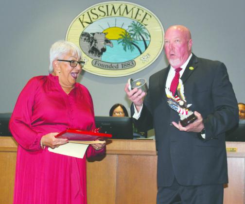 Outgoing Mayor Olga Gonzalez is presented with "parting gifts" — including a new watch — by City Manager Mike Steigerwald after eight years on the dais. PHOTO/KEN JACKSON