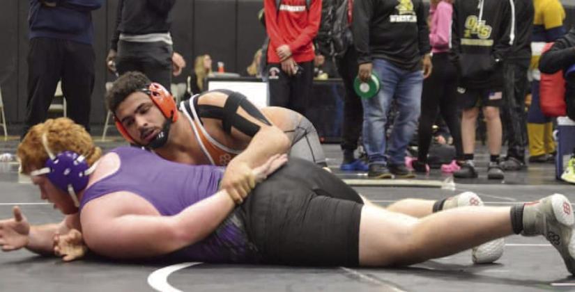 Harmony’s Nelson Toro (top) works over Palatka’s Mikade Harvey in the 285-pound finals of The Hammer Tournament in Jacksonville. Toro won the match, 11-1. PHOTO/HARMONY HIGH SCHOOL