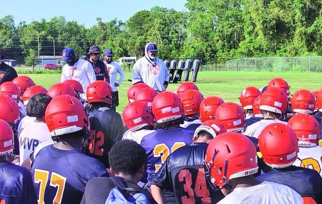 Tohopekaliga head coach Anthony Paradiso (center with hoodie) talks to his squad after the team’s first fall practice. The Tigers will battle St. Cloud, Harmony and Lake in District 7A-10 in 2024 in search of their first district title. PHOTO/J. DANIEL PEARSON