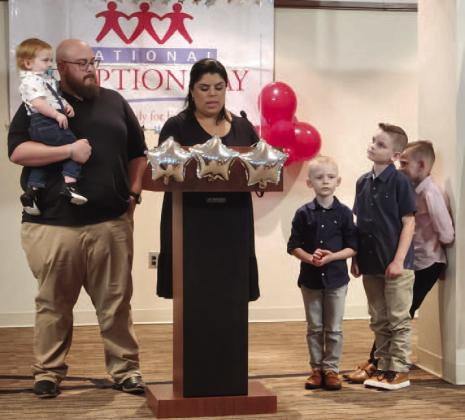 The Santos family — Israel, Dimaris, Noah, Oliver, Aries and Levi — share their adoption story Friday at a National Adoption Day in Florida event at the Osceola County Courthouse. PHOTO/KEN JACKSON
