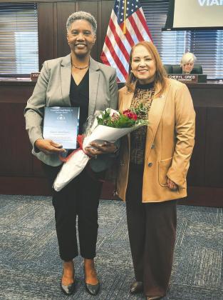 Osceola County Commissioner Viviana Janer presented Florida Department of Health-Osceola County administrator Vianca McCluskey with the Lieutenant Lloyd Burton Jr. Service Award Monday. (Photo/Ken Jackson)