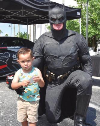 Batman (a.k.a. John Kalish) can be found providing children and families with books and other necessities through the year. A Hero for Kids will hold its Real Heroes Don’t Wear Capes gala Oct. 16. PHOTO/A HERO FOR KIDS