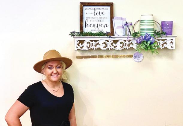 Morgan Phillips stands next to the memory wall in Little Piper Boutique. NEWS-GAZETTE PHOTO/BRIAN MCBRIDE