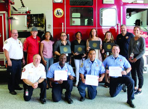Kissimmee Fire Department dispatchers, first responders and a medical air team pilot combined to save a local girl from drowning in April; KFD honored them last week. PHOTO/KEN JACKSON