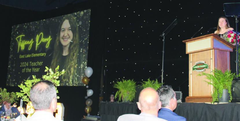 East Lake Elementary fifth-grade teacher Tiffany Perry accepts the Osceola County School District’s Teacher of the Year Award at last week’s ceremony. PHOTO/KEN JACKSON
