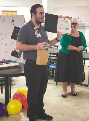 Marco Vivas, the latest graduate of Orlando Health’s WE BUILD internship program for adults with unique developmental and learning abilities, celebrates with program director Renee Pancoast. (Photos/Ken Jackson).