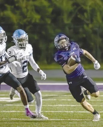 Celebration’s Kobe Orr runs from the Lake Region devense in Friday’s 21-6 Storm win. PHOTO/MARIO CASAMALHUAPA