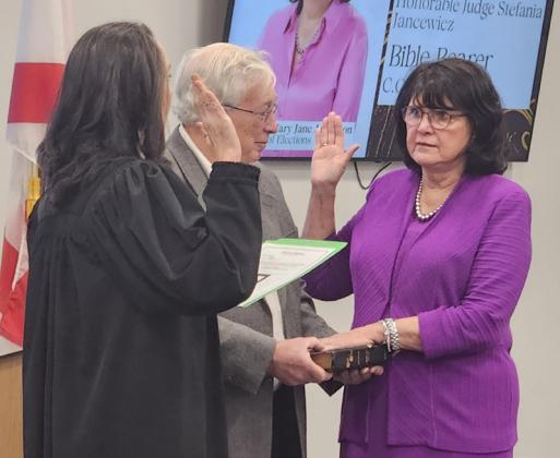 Osceola County Property Appraiser Katrina Scarborough, Supervisor of Elections Mary Jane Arrington were sworn in for their fifth terms, and Tax Collector Bruce Vickers his third, this week, joined by their families. PHOTO/KEN JACKSON