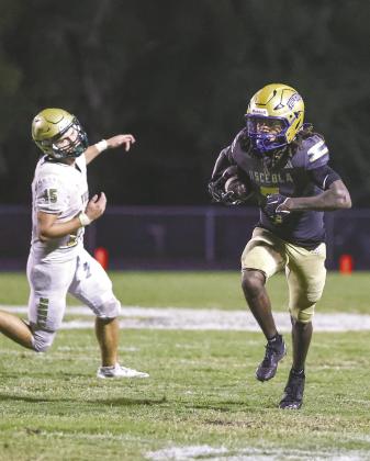 Jamari Lofton returns one of his two interceptions Friday, helping Osceola snare a 13-10 win over Viera and win the District 6A-5 title. (Photo/Taylor McFee)