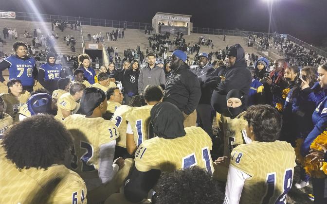 Osceola Coach Eric Pinellas addresses his team after a nail-biting 41-35 victory in Gainesville over Buchholz High School. The Kowboys will play for it all—the Class 6A state championship—against West Boca Raton at Florida International University. PHOTO/J. DANIEL PEARSON