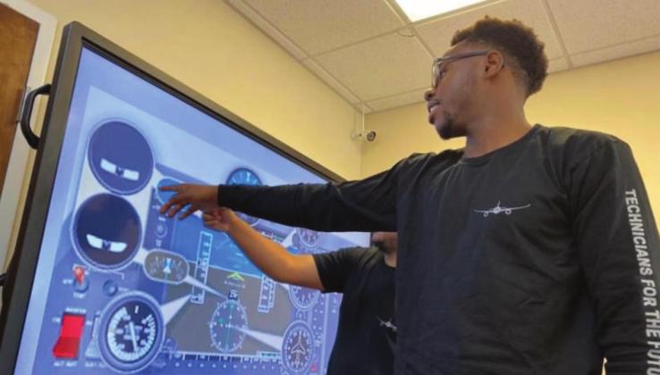 Avionica students study an interactive display of aircraft cockpit instrumentation. PHOTO/AVIONICA USA