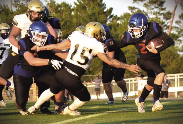 Harmony’s Rylan Rogers tries to gain yardage in the Longhorns’ spring game Thursday against East Ridge. PHOTO/KATIE WILLIAMS