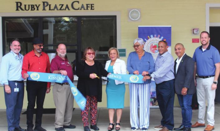 David and Janet Alvarez (second and fourth from left) celebrate the ribbon cutting for Ruby Plaza Café with City of Kissimmee officials. PHOTOS/KEN JACKSON