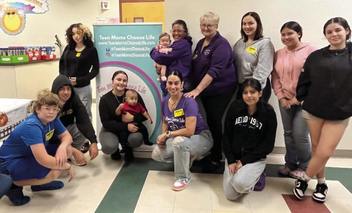 Debbie Newell (center, back row) and her Teen Moms Choose Life “big sisters” are working to provide community families a better Christmas. SUBMITTED PHOTO