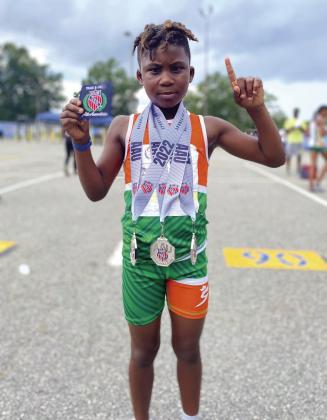 Kissimmee’s Masiah McGee took three silver medals among his eight-year-old competition at last week’s AAU Junior Olympic Championships in the 100, 200 and 400-meter runs. PHOTO/OSCAR MCGEE