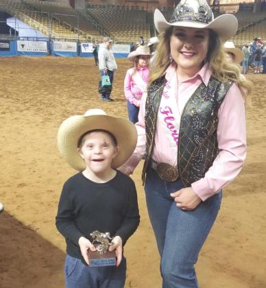 Seven-year-old Ian was one of the “big winners” at the Sunday’s Silver Spurs Special rodeo, with his buddy, Miss Rodeo Florida Makayla Baker. PHOTO/KEN JACKSON