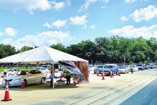 More than 700 vehicles lined up at Osceola Heritage Park on Monday during a COVID-19 testing event. NEWS-GAZETTE PHOTO/BRIAN MCBRIDE