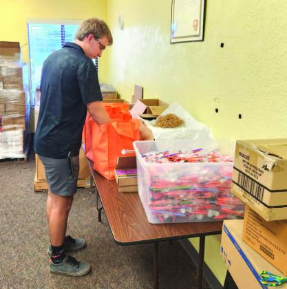 Like it’s done for 20 years, A Gift For Teaching staff puts together supply packages to be delivered to Osceola County schools in its personalized van. PHOTO/KEN JACKSON