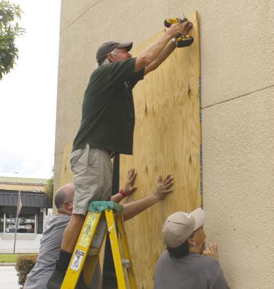 Downtown Kissimmee merchants prepared for Hurricane Milton on Oct. 9. It didn't bring the 100 mph winds that were possible, although some residents lost power for 24-28 hours. PHOTO/KEN JACKSON