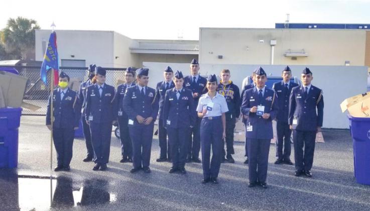 Cadet Staff Sgt. Shainaly DeJesus Diaz and Cadet Lt. Col. Angel Trejo (pictured with cards) earned gift cards for being the Osceola High male and female ROTC cadets to recycle the most Amazon cardboard boxes prior to the winter break. PHOTO/KEN JACKSON