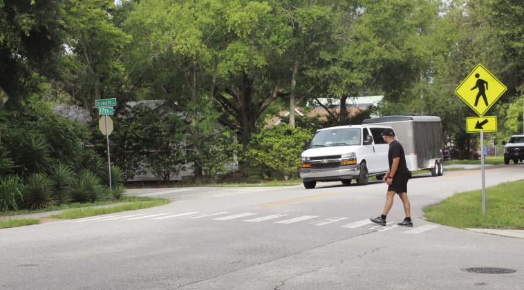 A St. Cloud Police officer crosses 17th Street Thursday during a Best Foot Forward crackdown on drivers who do not yield to pedestrians. PHOTO/KEN JACKSON