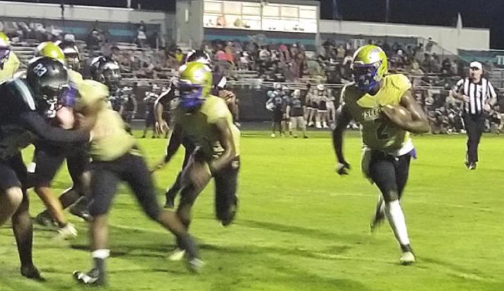 Osceola quarterback Chad Mascoe scrambles for a three-yard touchdown run in a 40-14 District 8A-9 win over Olympia Friday. PHOTO / KEN JACKSON