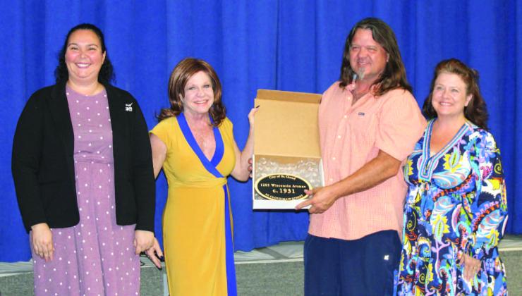 St. Cloud City Manager Veronica Miller and St. Cloud Main Street Executive Director present a historical plaque to Robert and Lori Winner, owners of a private residence at 1205 Wisconsin Ave. PHOTO/TERRY LLOYD