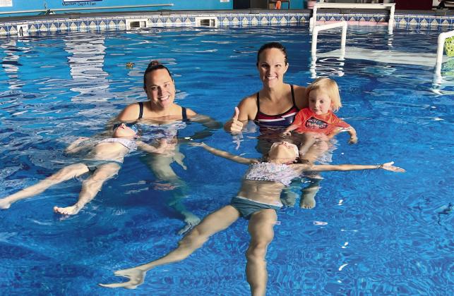 Rebecca Bond Abele (right) and Annemarie “Miss A” Atkinson spend their days giving children swim lessons — work they hope helps decrease the number of childhood drowning incidents. PHOTO/REBECCA BOND