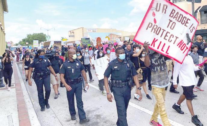 Law enforcement officers walked in unity with protesters in May to stand against police brutality after George Floyd was killed in Minnesota. The Kissimmee Police Department, St. Cloud Police Department and the Osceola County Sheriff’s Office all participated. NEWS-GAZETTE PHOTO/BRIAN MCBRIDE