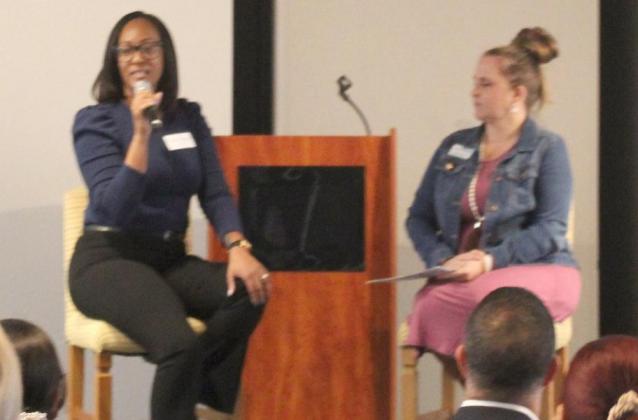 Melanie Figueroa of the Department of Children and Families (left) speaks with Commission 127 co-founder Betsey Bell. PHOTO/KEN JACKSON