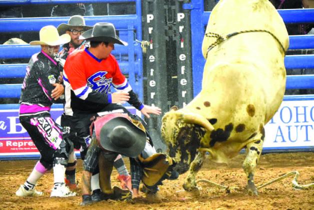 Bull riding can get complicated sometimes. PHOTOS BY KATIE WILLIAMS