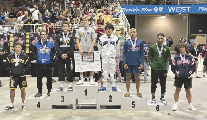 Osceola’s Anderson Heap stands on top of the podium after winning the FHSAA Class 3A State Wrestling Championship at 157 pounds. It was Heap’s third career state championship. PHOTO/OSCEOLA HIGH SCHOOL