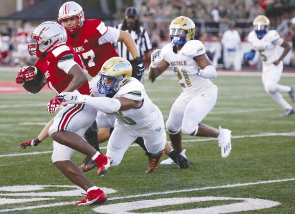 Top photo: Osceola linebacker Osceola linebacker Elijah Melendez brings down Lake Mary running back Isaiah Thomas in Friday’s 24-7 loss at Lake Mary. He had an interception in the game. PHOTO/TAYLOR MCFEE