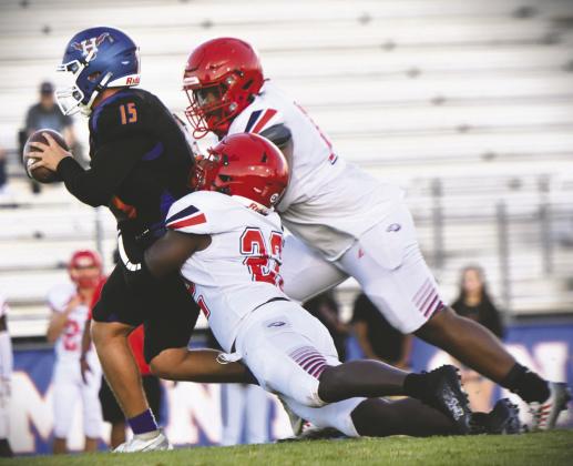 Right photo: Poinciana linebacker Ja’kobe Hines brings down Harmony quarterback Landon Hayes in Friday’s 26-5 Eagle victory at The Ranch Friday. WILLIAMS