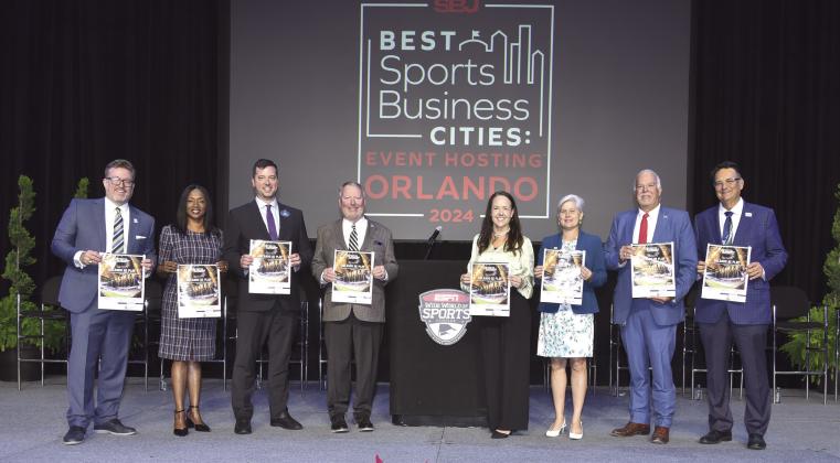 An event Monday to announce the Orlando area’s selection as the “Best Sports Business City for Attracting and Hosting Events” included Osceola County Commission Chair Cheryl Grieb (third from right). PHOTO/GREATER ORLANDO SPORTS COMMISSION