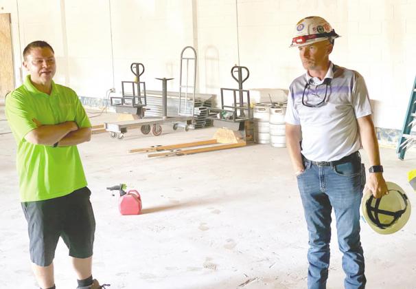 Krush Development CEO Waylon Krush, left, and Krush Development President and General Contractor David Monington stand in the facility where a German restaurant and brewery will be located. NEWS-GAZETTE PHOTO /BRIAN MCBRIDE