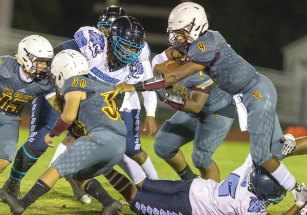 St. Cloud’s Jaden Morehead (9) runs the ball with a help of a block from Anthony Morales (30) in the Bulldogs’ 7-6 win over Akelynn’s Angels Academy Friday. PHOTO ROB HERBERT