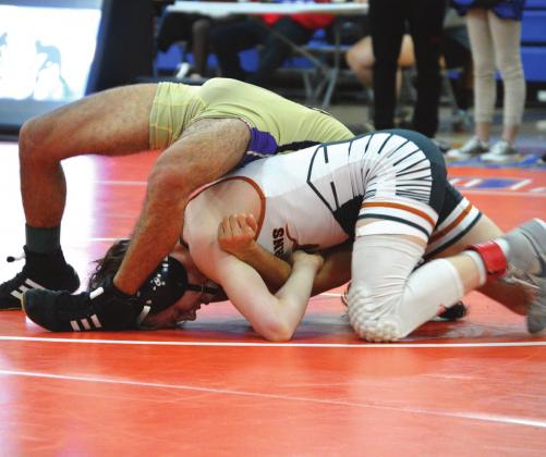 Harmony’s Aiden Poe (bottom) puts the finishing touches on an opponent, one of three pins he recorded in winning the 113-pound district championship. PHOTO COURTESY OF ANDIE HINMAN/HARMONY WRESTLING