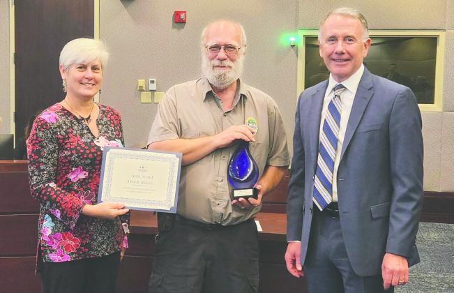 Allen Martin (center) received the Spirit of Osceola Award, given by the county to employees who reach 35 years of service. PHOTO/KEN JACKSON