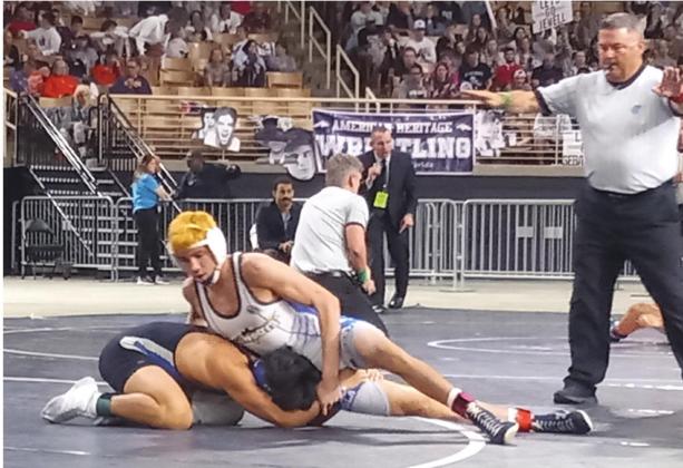 Cooper Haase (top) gets ready to turn Riverview’s Nikolas Hernandez in the Class 3A, 138-pound finals of the FHSAA state wrestling tournament to win his third state title. PHOTO/J. DANIEL PEARSON