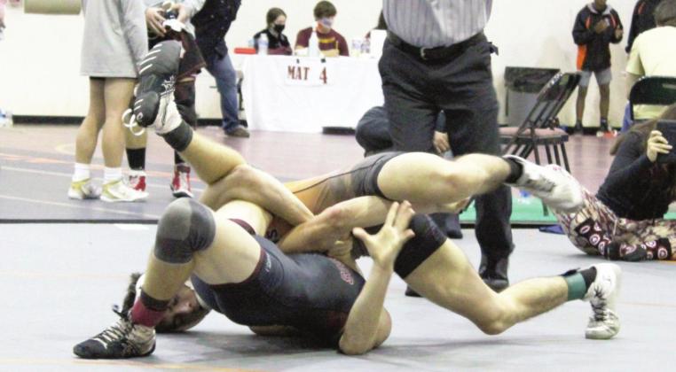 Harmony’s JC McNichols (top) pins an opponent during the Bulldog Classic. McNichols, wrestling in the 132-pound weight class, and teammate Aiden Poe (120), each went 7-0 in the two-day event as the Harmony finished second in the event. Photo courtesy of becky mcnichols