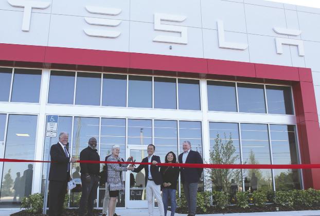See it refurbished, then take it home: used Teslas will be serviced to current standard then sold in the same facility—a company first. Company and county officials cut the ribbon on the Kissimmee facility Monday. PHOTO/KEN JACKSON