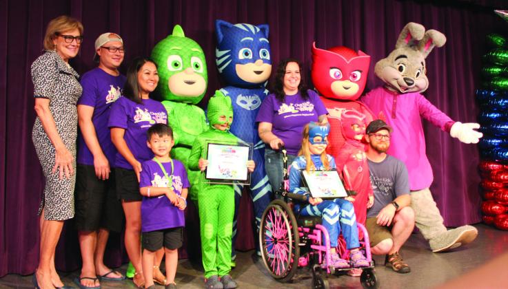 Give Kids the World premiered the “PJ Masks: In Real Life” videos of wish kids Kellan Hoang (as the green Gekko) and Madison Hendrickson (blue Catboy) and celebrated with their families Tuesday at the Kissimmee village. PHOTO/KEN JACKSON