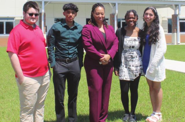 From left, Noah Crandall (Poinciana High), Anthony Polanco (NeoCity Academy), Poinciana Council Chair Crystal Bethea, Shenica Jerome (Liberty High) and Xiomaris Legarreta (Osceola School For the Arts) at Friday’s scholarship awards banquet at Poinciana’s Osceola Business Academy. PHOTO/KEN JACKSON