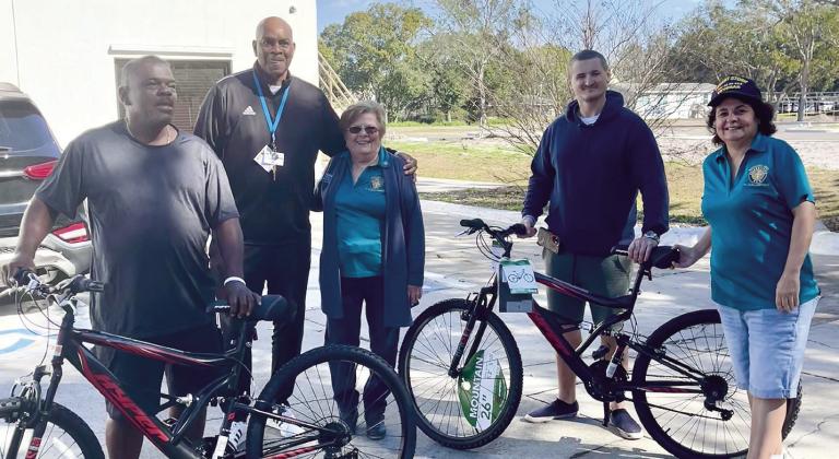 The Transition House’s Darryl Barnes, Larry Henry and Kyle Hilton, and the Columbiettes Auxiliary’s Jackie Choma and Tammy Fischer at Saturday’s bicycle presentation. PHOTO/DEBBIE DANIEL