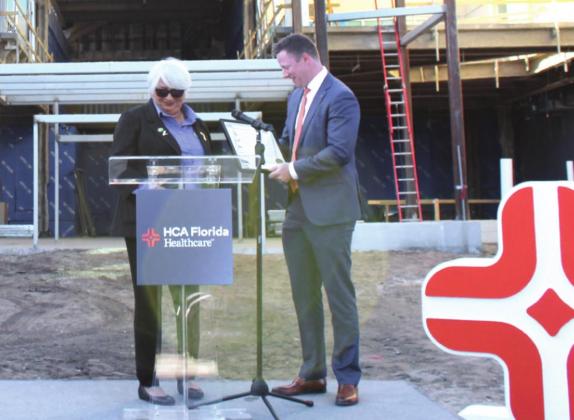 In the midst of the hospital’s expansion, Kissimmee Mayor Olga Gonzalez presents a proclamation to HCA Florida Osceola CEO David Shimp, calling “HCA Florida Health Care Day.” PHOTO/KEN JACKSON