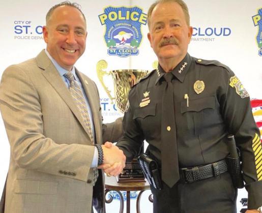 New St. Cloud Police Chief Douglas Goerke, left, is congratulated by retiring Police Chief Pete Gauntlett at a Tuesday ceremony. PHOTO/CITY OF ST. CLOUD