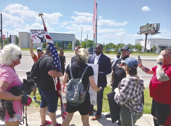 U.S. Rep. and gubernatorial hopeful Byron Donalds listened to protesters concerns at Saturday’s rally. PHOTO/LARRY GRIFFIN